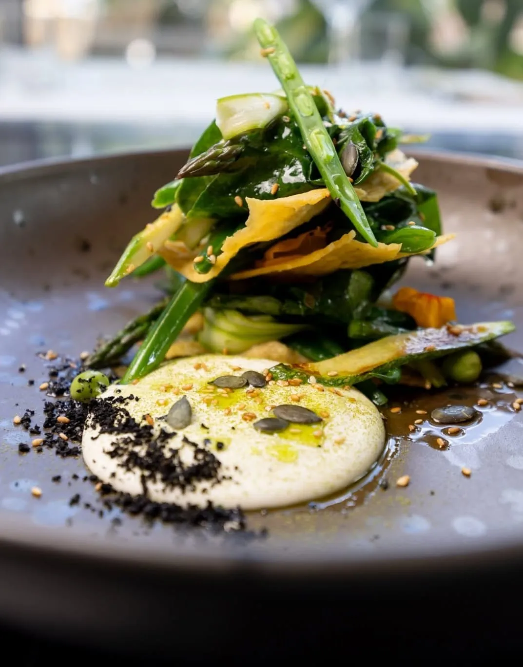 Asparagus and greens with a creamy sauce and seeds