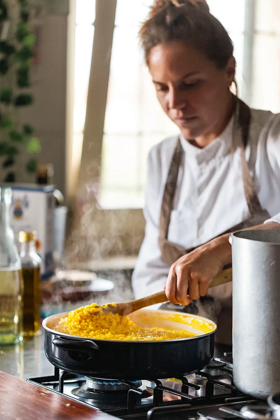 Sabrina stirring saffron risotto on the stove