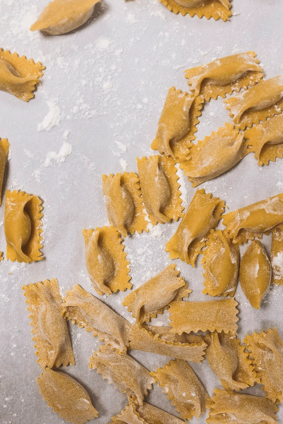 Handmade filled pasta on a floured surface