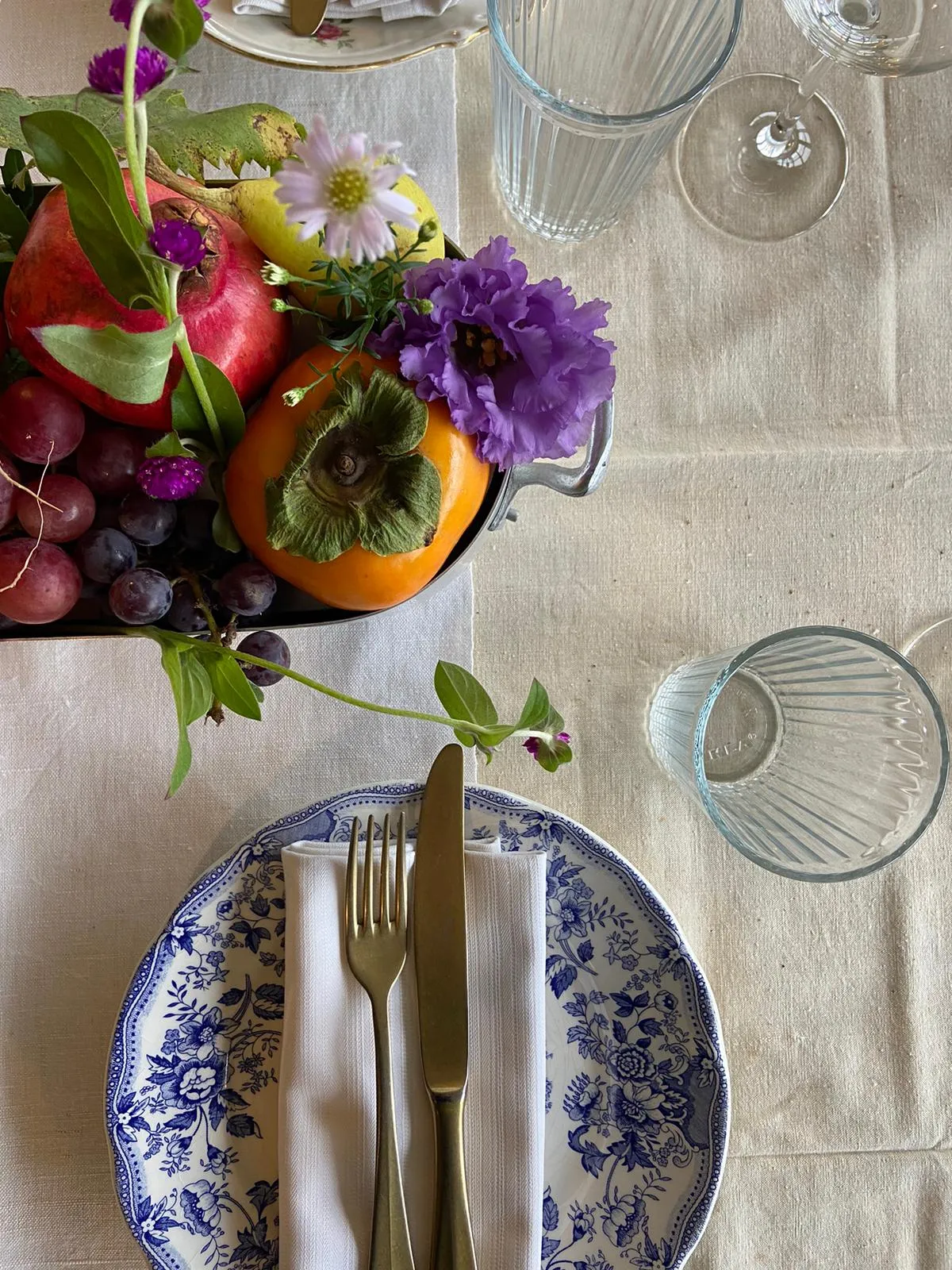 Fruit and flower centrepiece above a laid place setting