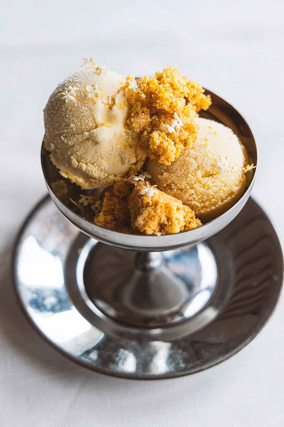 Gelato with crumble in a silver coupe